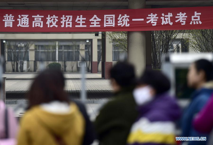 Parents wait outside the Tianjin No. 1 Middle School in Tianjin, north China, March 17, 2017. Students took part in the first test for English as part of China's National College Entrance Examination in Tianjin on Friday. As from 2017, two oral and written tests will be held for English during the National College Entrance Examination in Tianjin, and the better scores will be chosen as the final results. (Xinhua/Yue Yuewei)  