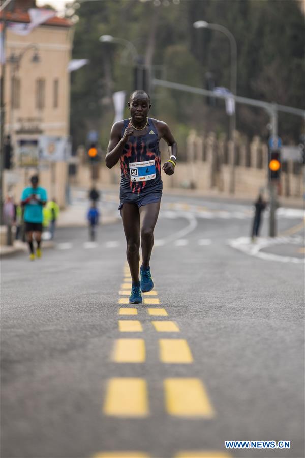 A runner takes part in the 7th International Jerusalem Winner Marathon in Jerusalem, on March 17, 2017. (Xinhua/Guo Yu)