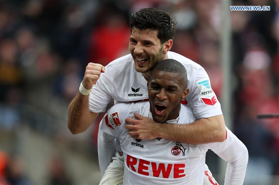 Anthony Modeste (Bottom) of 1. FC Koeln celebrates with teammate Milos Jojic after scoring during the Bundesliga match between 1. FC Koeln and Hertha BSC in Cologne, Germany, on March 18, 2017.