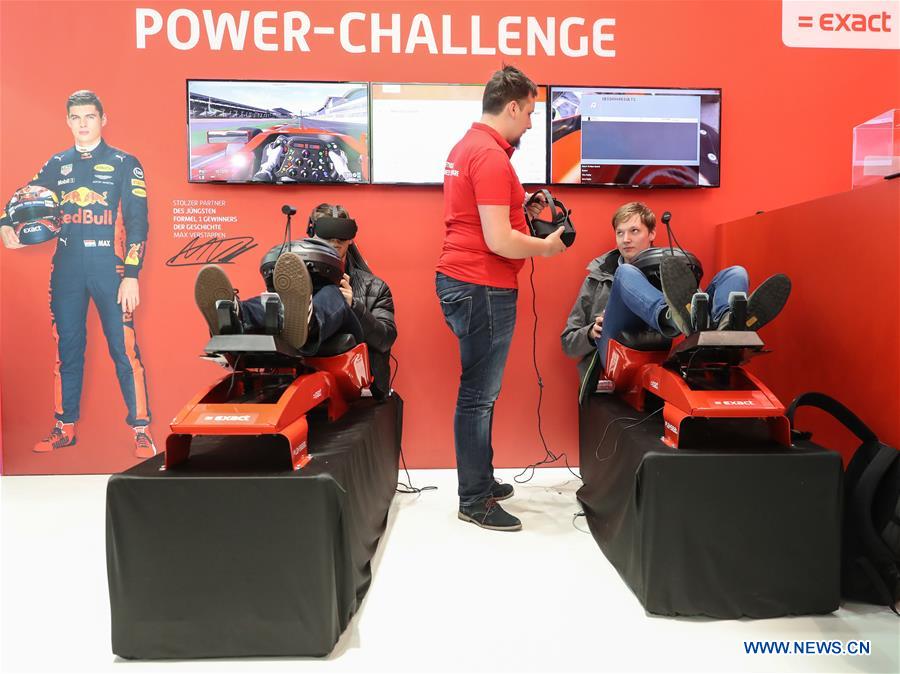 Visitors experience race car driving via VR technology at the Exact booth during the CeBIT 2017 in Hanover, Germany, on March 20, 2017. The world's leading trade fair showcasing IT and communications products and solutions CeBIT 2017 kicked off on Monday and will last until March 24. The show with the theme 'd!conomy - no limits' this year attracted around 3,000 exhibitors from 70 countries and regions and is expected to attract some 200,000 visitors. (Xinhua/Shan Yuqi) 