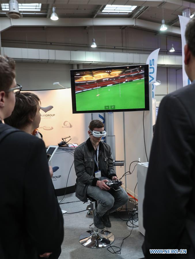 A visitor experiences drone control via VR technology at the Spectair Group booth during the CeBIT 2017 in Hanover, Germany, on March 20, 2017. The world's leading trade fair showcasing IT and communications products and solutions CeBIT 2017 kicked off on Monday and will last until March 24. The show with the theme 'd!conomy - no limits' this year attracted around 3,000 exhibitors from 70 countries and regions and is expected to attract some 200,000 visitors. (Xinhua/Shan Yuqi) 