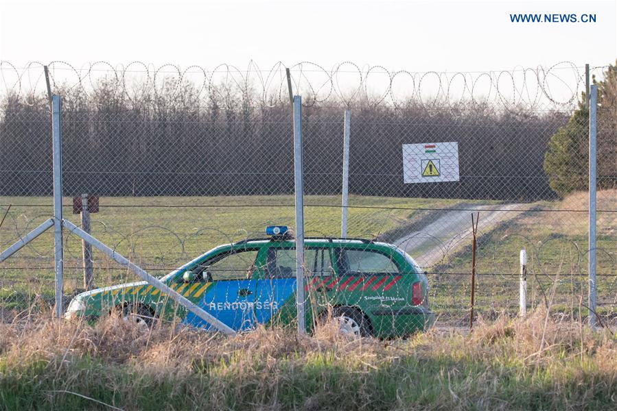 A Hungarian police car patrols between the two border fences on the Hungarian-Serbian border near Kelebia, Hungary on March 20, 2017. 