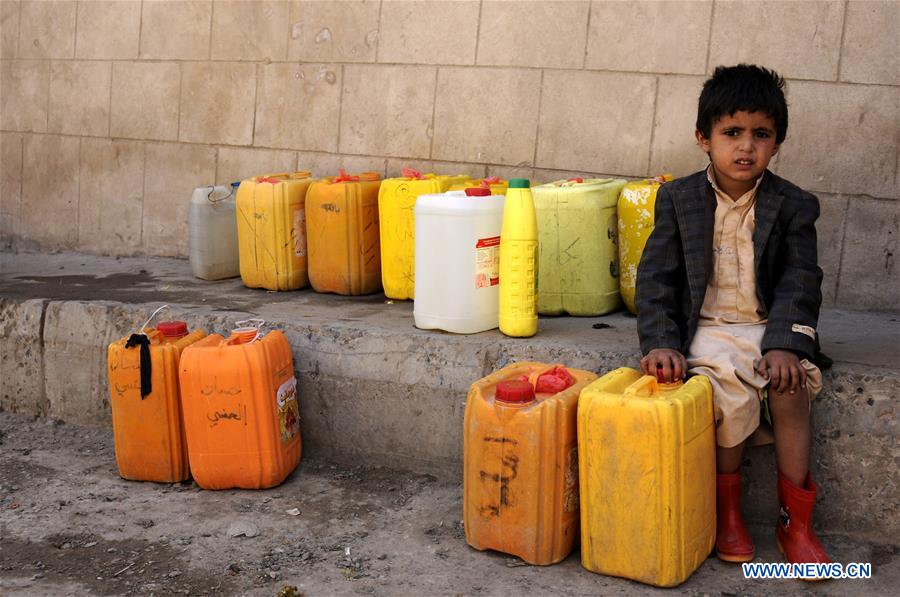 A child waits to receive food and water from a charity food distributing center in Sanaa, Yemen, on March 20, 2017. (Xinhua/Mohammed Mohammed) 