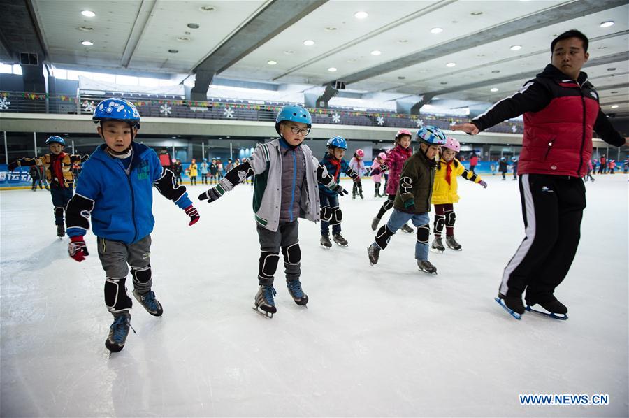 Pupils take a skating class in the ice rink located in Nanjing Olympic Center in Nanjing, capital of east China's Jiangsu province, March 7, 2017. With more and more people from south and west China participating in winter sports, the popularity of winter sports in east China's Jiangsu province began to grow fast. In recent years, 13 ice rinks using social capital have been opened in Jiangsu. The operators of these ice rinks established clubs to attract more than 100,000 people to practice skating. The Century Star Rink located in Nanjing Olympic Center is the biggest indoor ice rink in Nanjing. The club only had dozens of members in 2008, but now it has more than 20,000 members. At the mean time, the club cooperates with 8 elementary schools in neighborhood to open classes teaching skating skills. About 10,000 pupils learned the basic skills of skating and 4 ice hockey squads were founded in last 9 years. A total of 15 small outdoor ski resorts have also been set up in northern Jiangsu province. During the last snow season, which is only two months due to warm weather here, these ski resorts accommodated around 10,000 person-times of visitors. (Xinhua/Li Xiang)