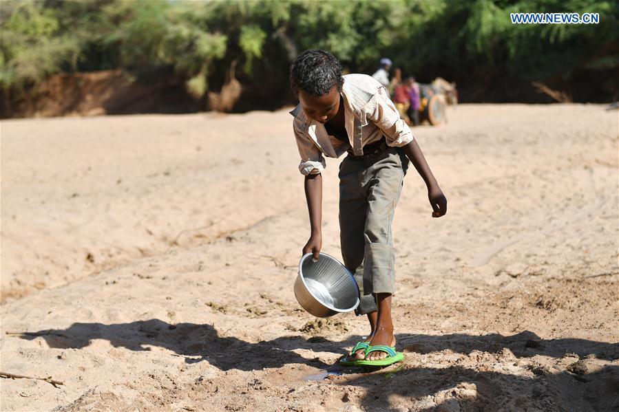 A boy washes his feet on the dried-up riverbed near Doolow, a border town with Ethiopia, Somalia, on March 20, 2017. 