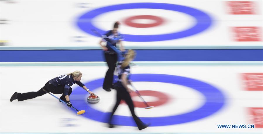 Anna Sloan (L) of Scotland delivers a stone during the bronze medal match against Sweden at the CPT World Women's Curling Championship 2017, in Beijing, capital of China, March 26, 2017. 