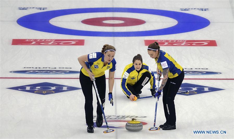 Anna Hasselborg (C) of Sweden delivers a stone during the bronze medal match against Scotland at the CPT World Women's Curling Championship 2017, in Beijing, capital of China, March 26, 2017.