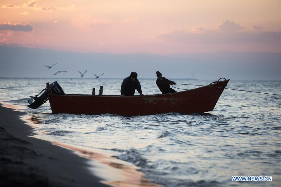 Iranian fishermen work at the Caspian sea beach near Anzali Port, northern Iran, on March 27, 2017. (Xinhua/Ahmad Halabisaz) 