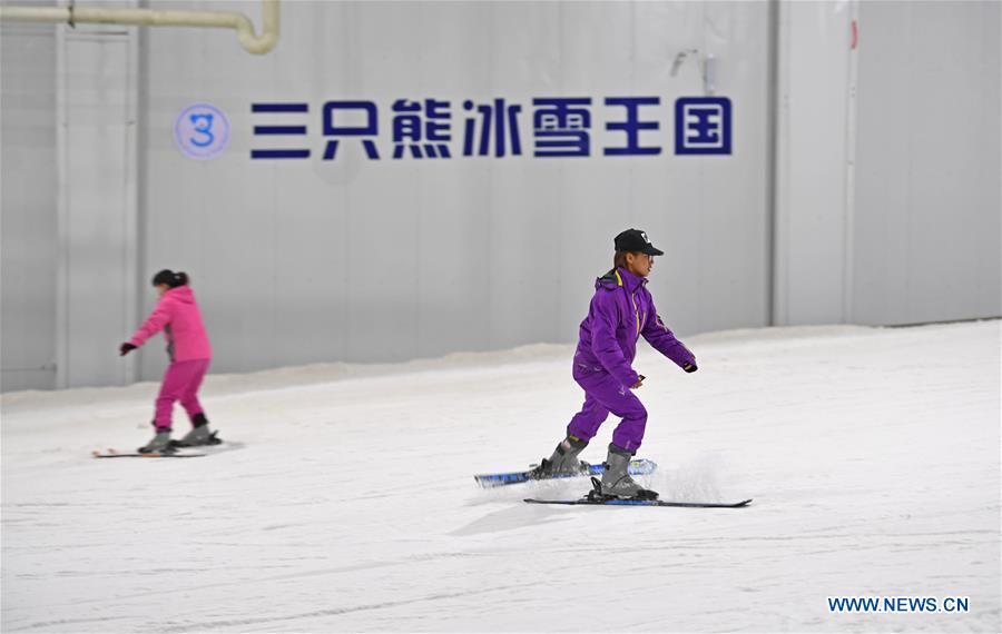 People ski in 'Snow Kingdom of Three Bears' in Changsha, capital of central China's Hunan Province, on March 8, 2017. 