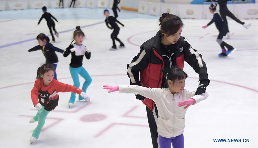 A coach instructs a girl practising figure skating in an ice rink located in a shopping mall in Chengdu, capital of southwest China's Sichuan Province, Feb. 25, 2017.