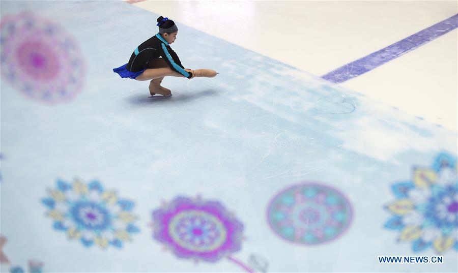 A girl practises figure skating in an ice rink located in a shopping mall in Chengdu, capital of southwest China's Sichuan Province, Feb. 25, 2017.