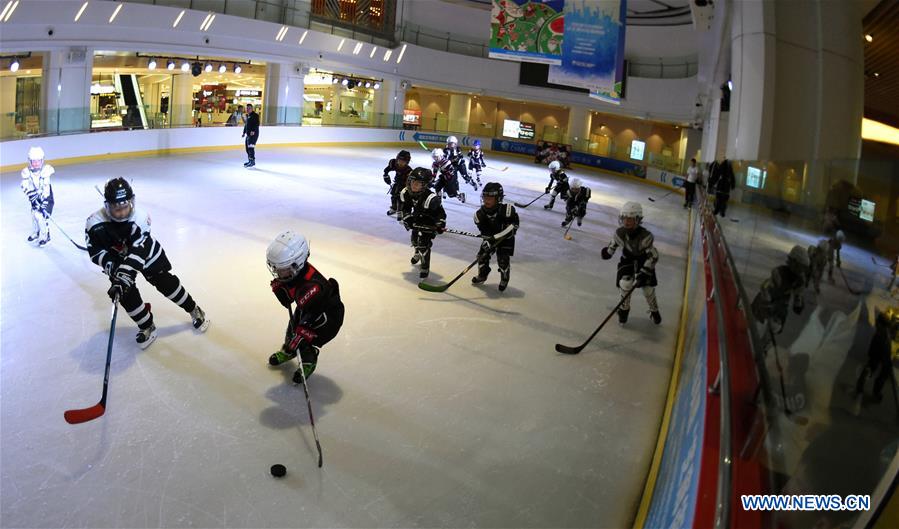 Boys play ice hockey in the Century Star Rink in Kunming, capital of southwest China's Yunnan province, March 18, 2017. 