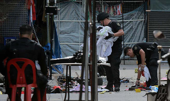 Policemen investigate blast site in Manila, the Philippines