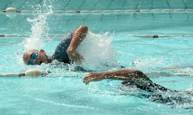 Children take part in 100m freestyle swimming in Indonesia Autism Games