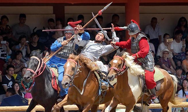 Performers demonstrate sword fighting on horseback in Kaifeng