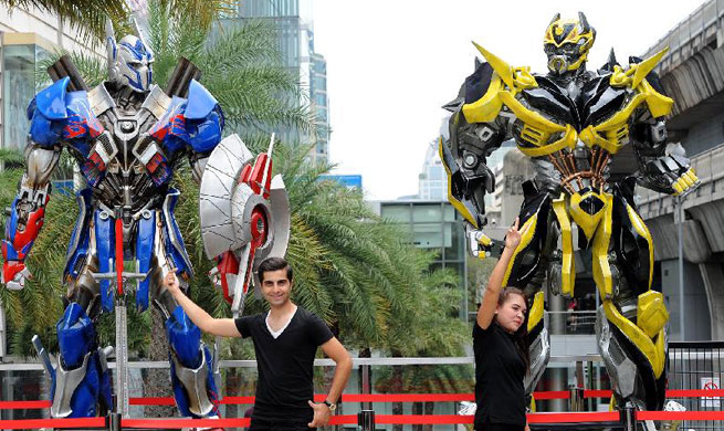 Scale figures of Transformers characters attract tourists in Bangkok