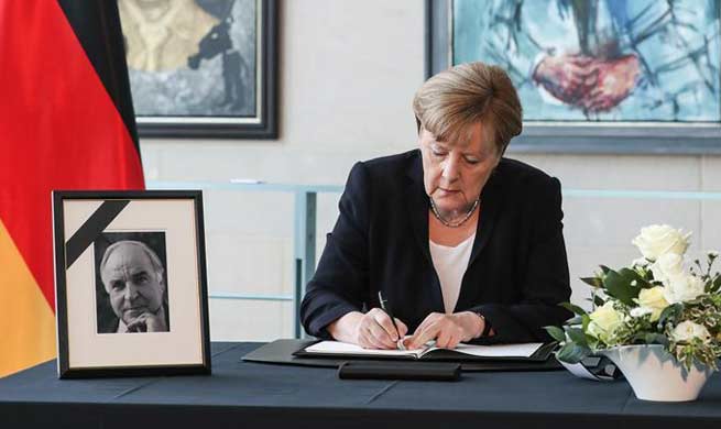 Angela Merkel signs condolences book for former German Chancellor