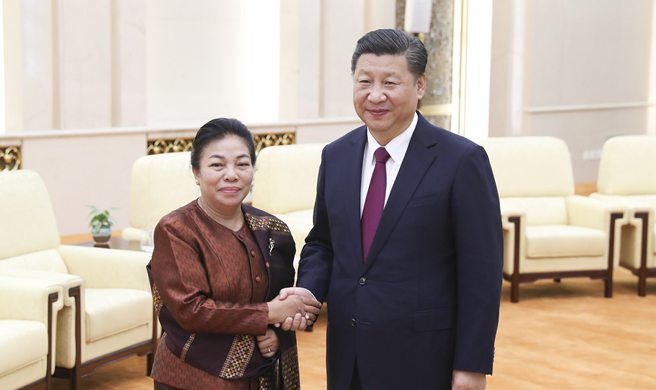 Ruling parties of China, Laos pledge further cooperation for closer bilateral ties