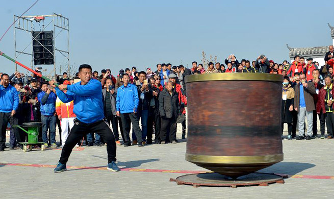 Competitors whip 2,000 kilograms top at top game in C China's Henan