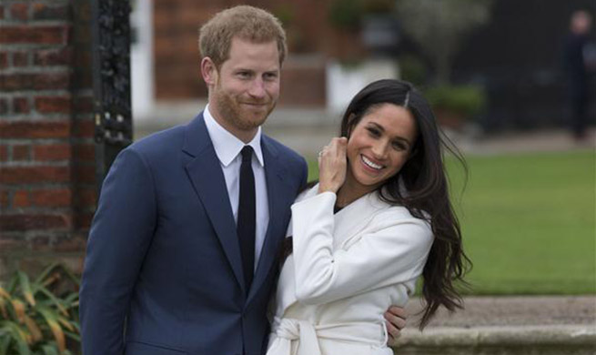 Britain's Prince Harry engages with American actress Meghan Markle