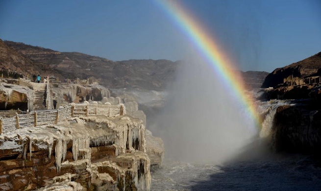 Rainbow arching over Hukou Waterfall of Yellow River