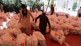Afghan people receive relief goods during Ramadan