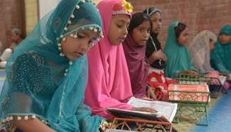 Bangladeshi Muslim children read Quran at mosque during Ramadan