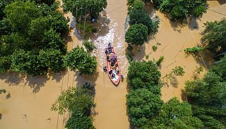 Rescuers evacuate trapped villagers in rain-hit Zhejiang