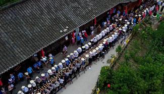 People enjoy meal during "Helong Banquet" in central China