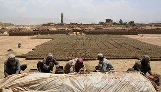 Afghan men work at brick factory in Kabul