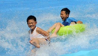 Children play in water park in NE China