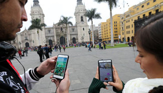 People play "Pokemon Go" in Lima, Peru