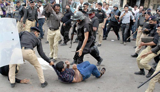 One dies as political activists attack TV channel office in Pakistan's Karachi