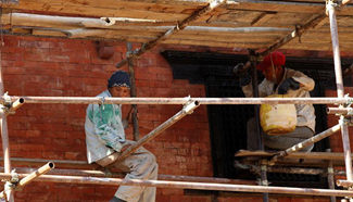 People work at reconstruction site in Nepal