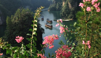 Tourists take boats at Baofeng scenic area in Zhangjiajie