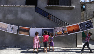Palestinian photographer decorates walls of refugee camp with photos