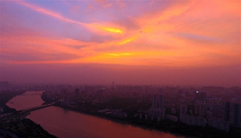 Red clouds at dusk glow in sky over S China's Nanning City