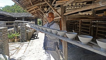 Ceramists make porcelains at Ancient Kiln and Folk Customs Museum in Jingdezhen