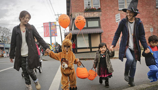 Canadian children walk in street for trick-or-treat during Halloween day
