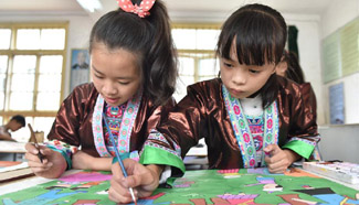 Children learn traditional farmer painting of Dong ethnic group in S China
