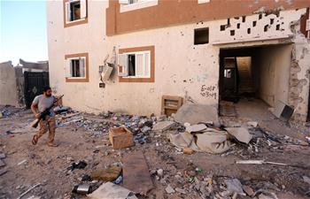 Members of forces loyal to Libya's GNA guard look-out point in Sirte