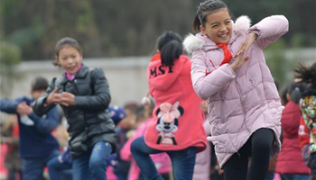 Pupils learn traditional hand-waving dance of Tujia ethnic group