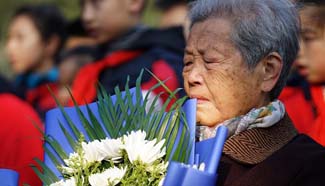 Nanjing Massacre survivors mourn victims in east China