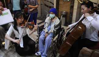 People play music for patients to welcome Christmas in Jakarta