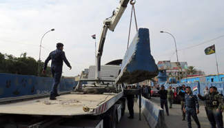 Iraqi security force remove cement road blocks from checkpoint in Baghdad
