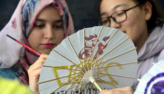 Int'l students paint on umbrellas to greet Year of Rooster
