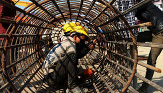 Workers install iron beams in Kalanki, Nepal