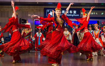 Artists perform for passengers at Beijing West Railway Station