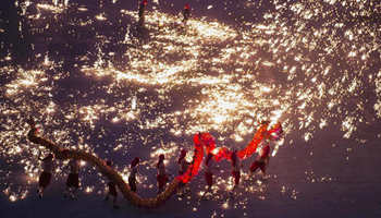People perform fire dragon dance to greet upcoming Spring Festival