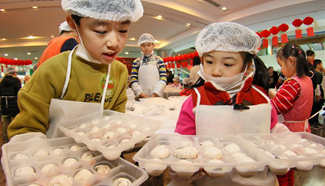 Children learn to make Yuanxiao in E China to mark Lantern Festival
